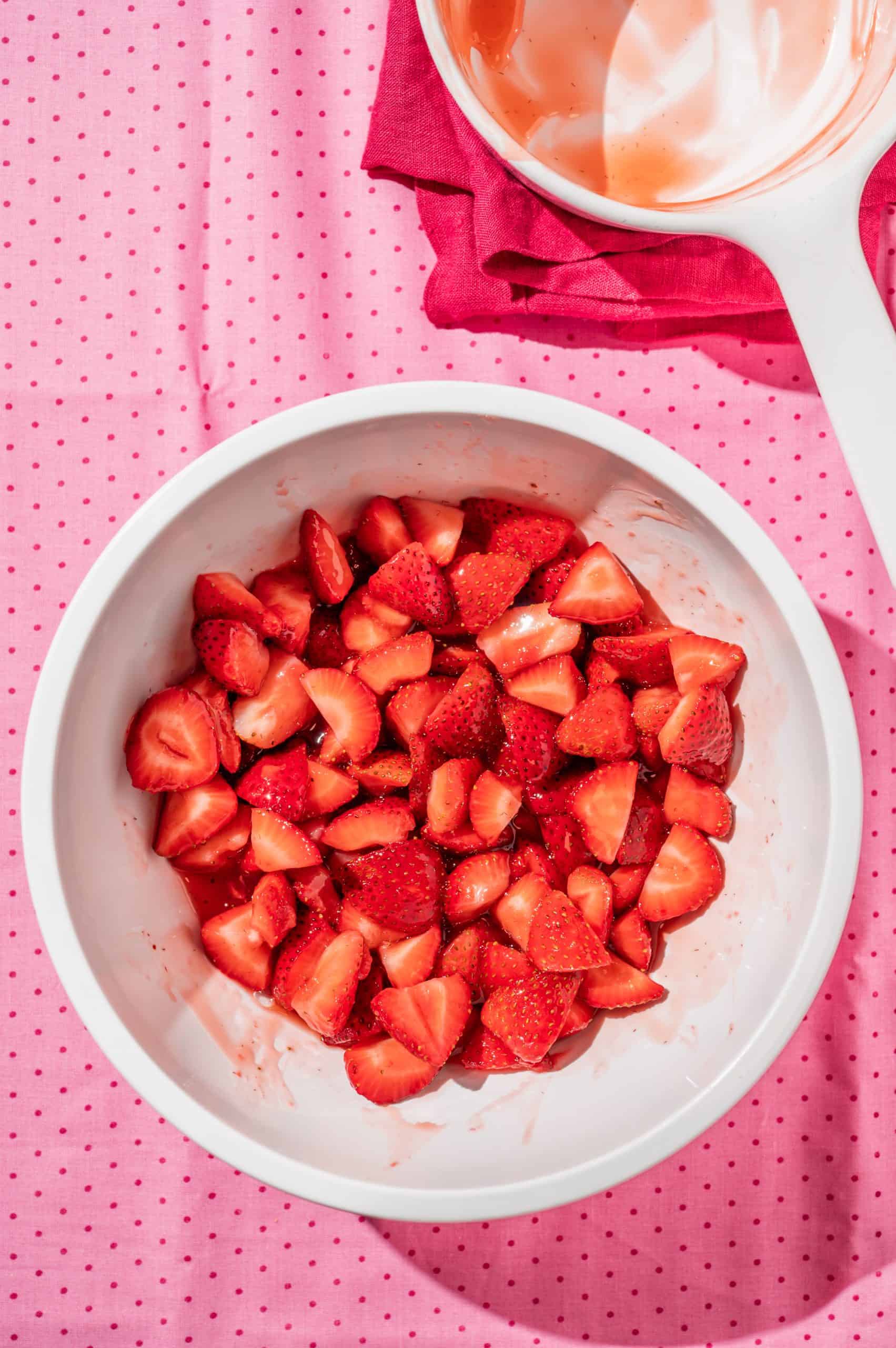 bowl of quartered strawberries in a slightly thickened strawberry juice