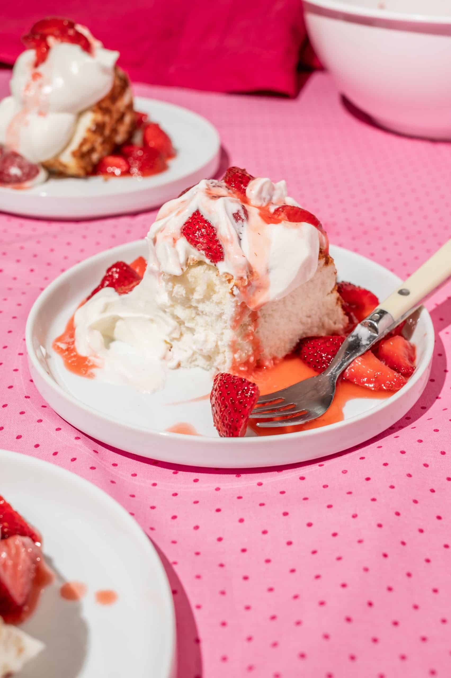 piece of strawberry shortcake angel cake with a bite taken out