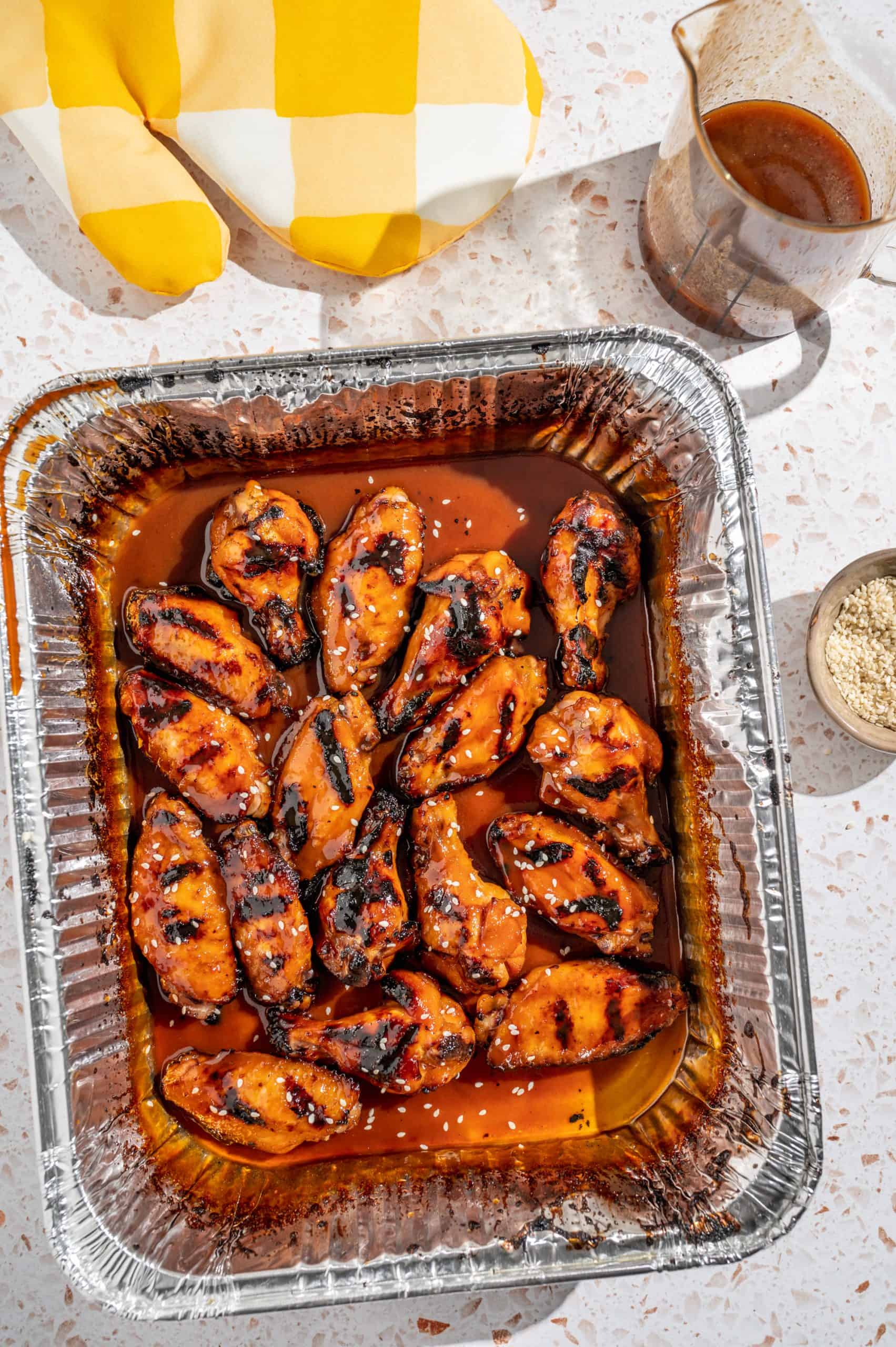 Crispy grilled chicken wings tossed with Asian sweet sticky sauce in a grill pan