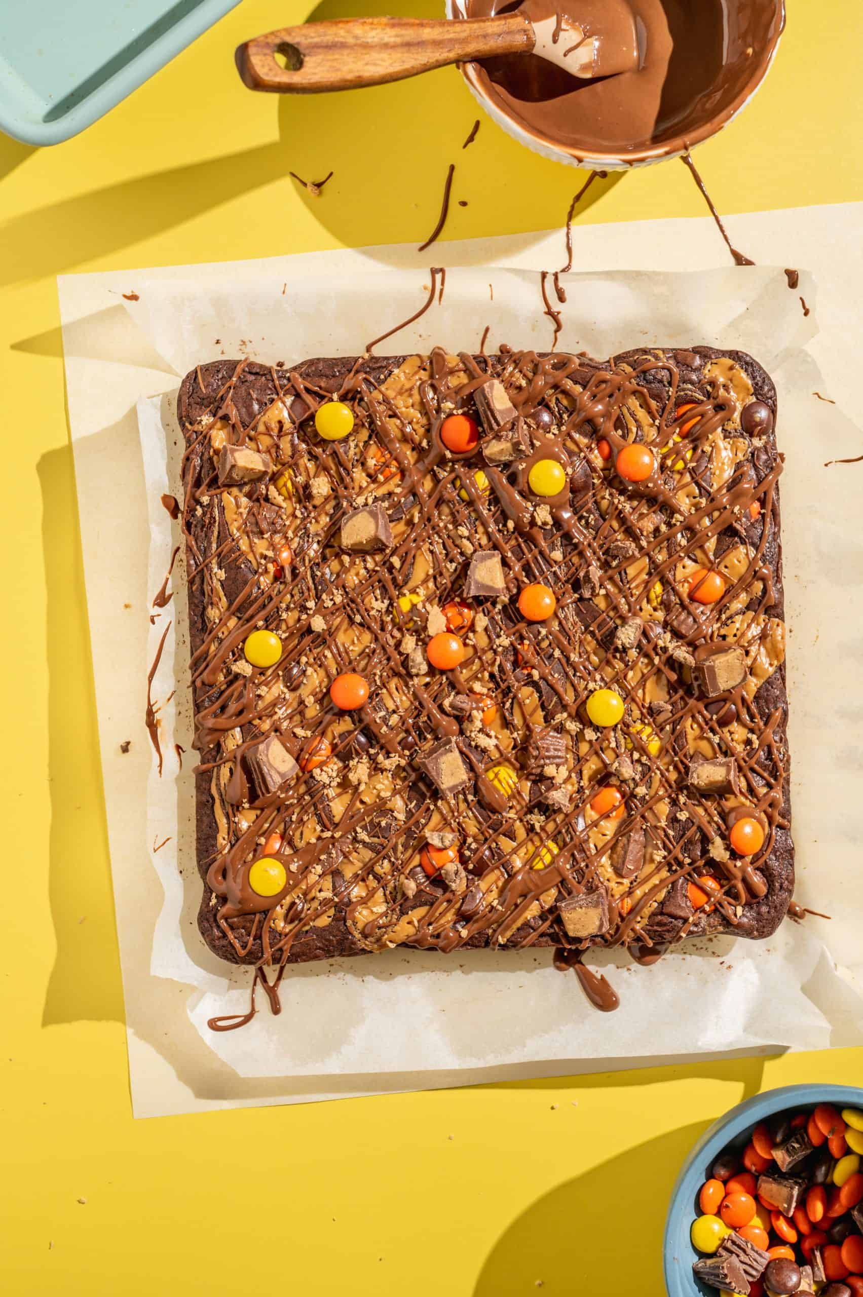Brownies drizzled with chocolate peanut butter mixture and topped with Reeses candy