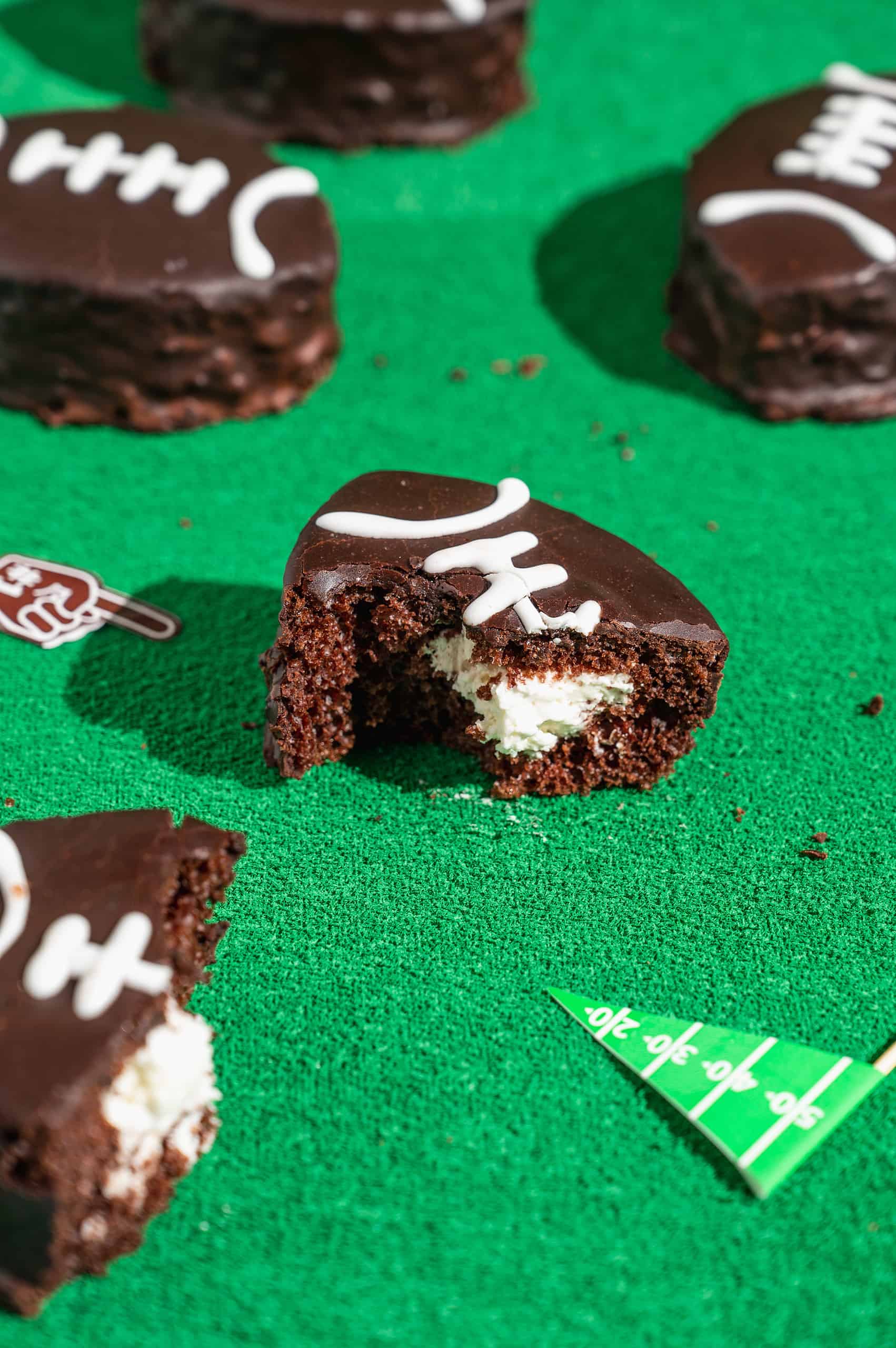 mini football cake with a bite taken out to expose cream filling
